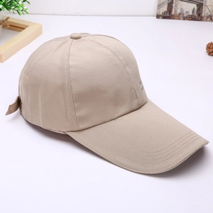Detail of a khaki cotton baseball cap with an extended brim and metal adjustment buckle