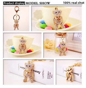 Detail view of gold teddy bear keychain with white rhinestones and heart hollow back