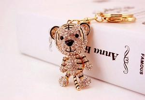 Macro shot of tiger keychain with gold plating and glittering pave white crystals