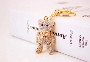 Macro view of gold teddy bear keychain with white crystal rhinestones and lobster clasp