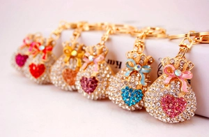 Detail shot of sparkling rhinestone money bag keychains in six vibrant assorted colors