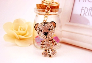 Detailed close-up of a sparkling gold tiger keychain with crystals and enamel details