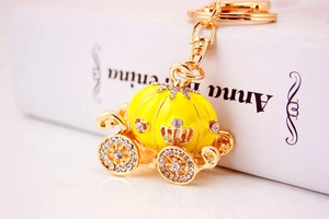 Detailed view of yellow crystal pumpkin carriage keychain with gold plating and rhinestones