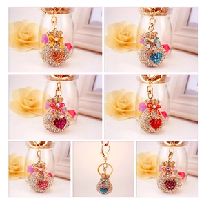 Macro shot of colorful rhinestone-studded lucky bag keychains in six vibrant colors