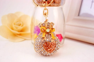 Close-up of diamond lucky bag keychain with orange heart crystal and golden lobster clasp