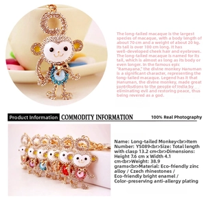 Macro detail of monkey keychain showing sparkling crystals and colorful enamel finish
