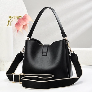 Detailed view of the black lychee grain leather bucket bag with gold-tone hardware