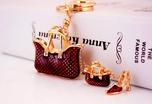 Detailed close-up of wine red enamel handbag charms and stiletto keychain with rhinestones