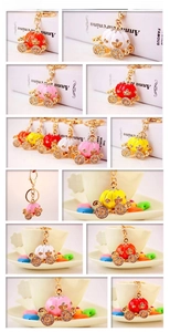 Detail view of pumpkin carriage keychains in five colors with sparkling rhinestones