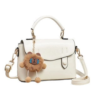 Elegant cream white PU leather handbag for women featuring a cute brown plush bear charm