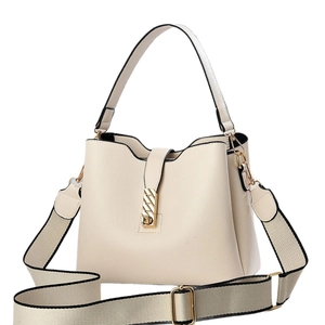 Elegant cream bucket bag in pebbled leather with trendy woven shoulder strap