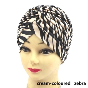 Front view of a twisted turban headwrap featuring a stylish cream zebra animal print