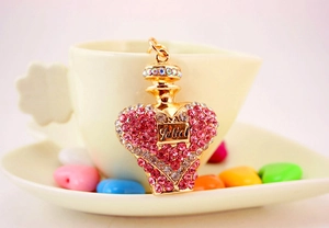Detail of crystal-encrusted Juliet perfume bottle keychain with pink and gold accents