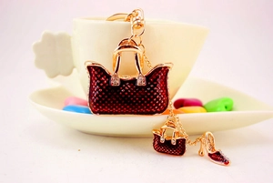 Detail of red polka dot handbag and high heel keychain pendants with sparkling rhinestones