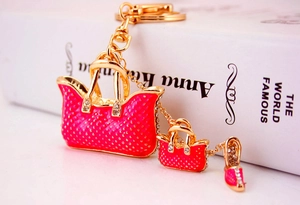 Close-up of pink enamel handbags and high-heel pendants with sparkling rhinestones