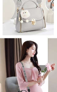 Detail view of grey lychee leather handbag featuring golden lock and jacquard strap