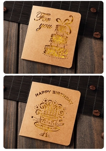 Macro view of kraft paper greeting cards with hollow-carved birthday and gift patterns