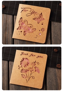 Detail of laser-cut butterfly and floral patterns on vintage kraft paper cards