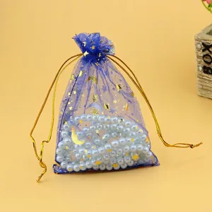 Dark blue organza jewelry pouch with gold star moon patterns and drawstring