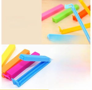 Detailed view of colorful plastic food sealing clips with deep inner grooves for freshness