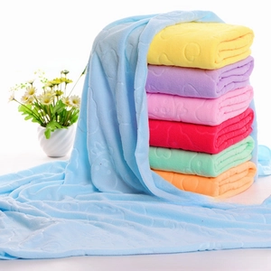 Detailed view of colorful microfiber towels with embossed bear and heart patterns