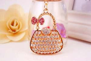 Detailed close-up of a sparkling rhinestone handbag keychain with pink bow decoration