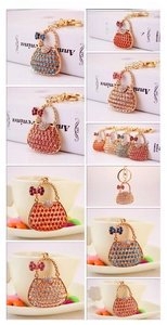 Detail showing colorful rhinestone handbag keychains in red, blue, and pink gold metal