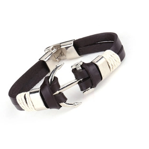Detail of a brown leather men's bracelet featuring a silver anchor clasp and woven rope decor