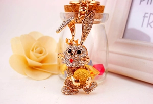Close-up of golden cartoon rabbit keychain with sparkling rhinestones and lobster clasp