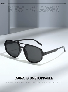 Detail of classic double-bridge pilot sunglasses in black within a minimalist setting