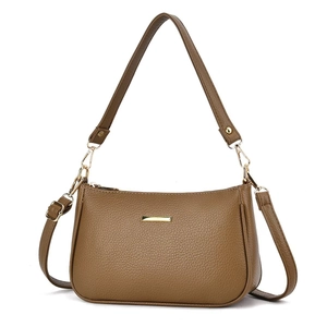 Minimalist brown pebbled leather crossbody bag with golden hardware and dual straps