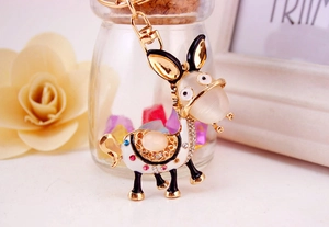 Close-up of golden donkey keychain with colorful rhinestones and enamel details
