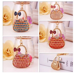 Detail view of sparkling rhinestone handbag keychains in blue, red, pink, and white crystal
