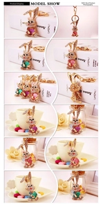 Macro detail of rhinestone-studded rabbit keychain with golden metal clasp and bow