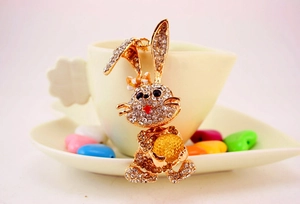 Detailed view of a gold-plated rabbit keychain with sparkling rhinestones and crystal ball