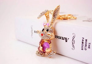 Close-up of golden rabbit keychain with sparkling rhinestones and pink bow detail
