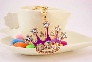 Macro shot of crown keychain featuring purple enamel and sparkling crystal rhinestones
