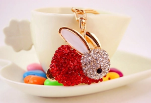 Détail d'un porte-clés lapin mignon avec strass rouges et fermoir en métal doré brillant