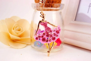 Detailed close-up of pink rhinestone ballet girl keychain with golden alloy finish