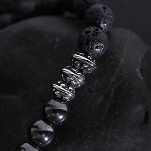 Lava rock and steel bead bracelet for men featuring a carved silver-tone cross charm