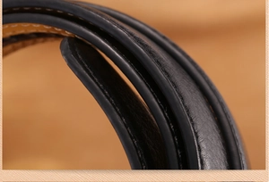 Close-up of black leather belt showing textured grain, stitching, and smooth oiled edges