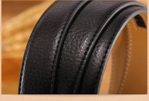 Macro shot of black and brown leather belt edges with detailed stitching texture