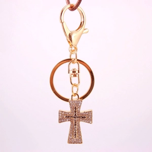 Elegant gold cross keychain with sparkling crystals for car keys or handbags