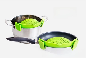 Detailed view of green silicone clip-on strainer fitting various pot sizes and edges