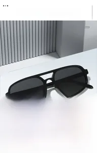 Detail view of modern black double bridge sunglasses on a white minimalist display stand