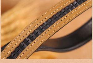 Macro shot of brown leather belt showing fine stitching and internal black ratchet tracks