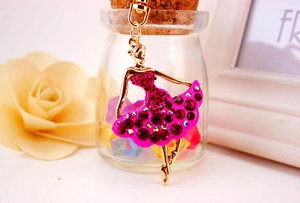 Detailed macro view of ballet girl keychain with pink rhinestones and golden lobster clasp