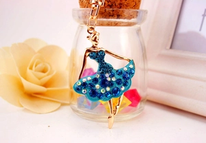 Detail of blue enamel ballerina keychain with sparkling crystals and golden frame