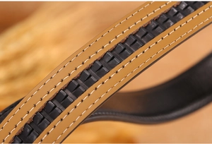 Detailed close-up of brown and black leather belt with white double stitching