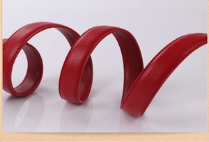 Detail of red lychee grain cowhide leather strap with precise stitching and spiral texture